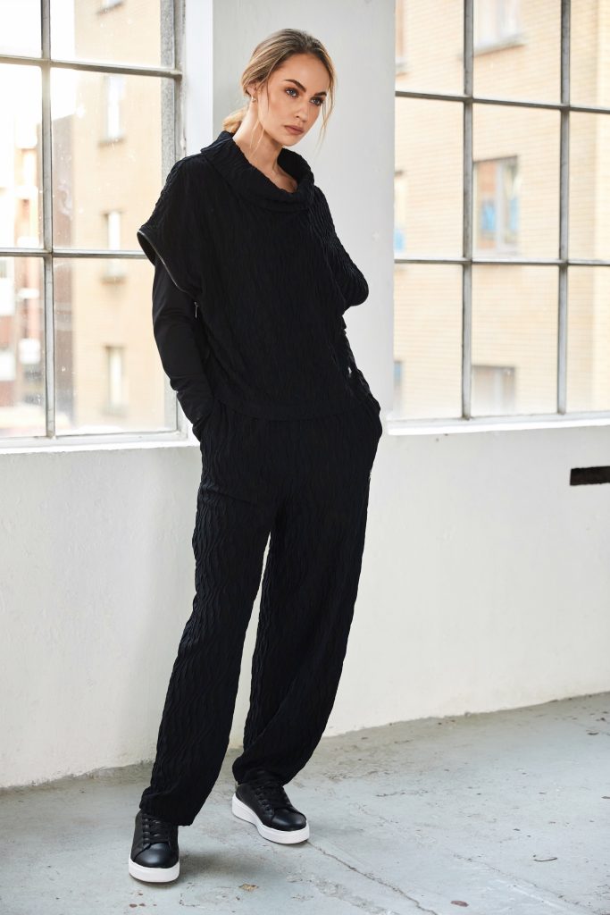 Embossed knit top with collar and zip detail on side seam Description